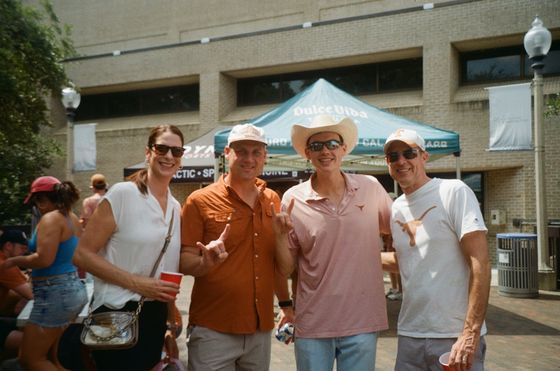Guests in front of a sponsor tent at the tailgate.